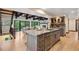 Spacious kitchen with stainless appliances, an island with a sink, and a view to the living room at 1298 Meadow View Dr, Evergreen, CO 80439