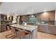 Large kitchen island with seating for three, stainless steel appliances, and granite countertops at 1298 Meadow View Dr, Evergreen, CO 80439