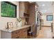 Kitchen area with a desk, stainless steel appliances, and views of the outside at 1298 Meadow View Dr, Evergreen, CO 80439