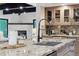 Close-up view of the kitchen island with a large sink, stainless dishwasher, and view to the fireplace at 1298 Meadow View Dr, Evergreen, CO 80439