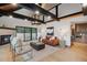 Modern living room with stone fireplace and sliding doors for outdoor access at 1298 Meadow View Dr, Evergreen, CO 80439