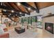 Open-concept living area features a fireplace, high ceilings, and large windows at 1298 Meadow View Dr, Evergreen, CO 80439