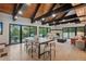 Open-concept living area featuring a fireplace, deck, and large dining space at 1298 Meadow View Dr, Evergreen, CO 80439