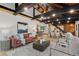 Spacious open-concept living area with hardwood floors and exposed-beam ceilings at 1298 Meadow View Dr, Evergreen, CO 80439