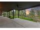 Covered porch with ceiling fan, offering views of the lush greenery and serene landscape at 1298 Meadow View Dr, Evergreen, CO 80439
