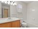 Clean bathroom featuring a vanity, toilet, and tub with tiled surround at 9860 Burberry Way, Highlands Ranch, CO 80129