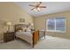 Cozy bedroom with vaulted ceiling, ceiling fan, and a large window providing natural light at 9860 Burberry Way, Highlands Ranch, CO 80129