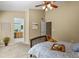 Comfortable bedroom featuring neutral walls, ceiling fan, and access to an ensuite bathroom at 9860 Burberry Way, Highlands Ranch, CO 80129