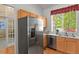 Well-lit kitchen with stainless steel appliances, ample cabinet space, and hardwood floors at 9860 Burberry Way, Highlands Ranch, CO 80129