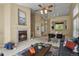 Spacious living room featuring a fireplace, seamless flow to the dining area, and natural light at 9860 Burberry Way, Highlands Ranch, CO 80129
