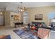 Bright living room with a connected dining area, view to the kitchen, and comfortable seating at 9860 Burberry Way, Highlands Ranch, CO 80129