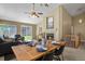 Inviting living room with a cozy fireplace, adjacent dining area, and backyard access at 9860 Burberry Way, Highlands Ranch, CO 80129