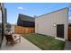 Cozy backyard with patio, chairs, and landscaped lawn at 3285 Lawrence St, Denver, CO 80205