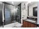 Sleek bathroom with glass-enclosed shower, black tile, and contemporary fixtures at 3285 Lawrence St, Denver, CO 80205