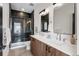 Modern bathroom features double sinks, wood cabinets, and a large glass shower with black tile at 3285 Lawrence St, Denver, CO 80205
