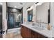 Modern bathroom featuring double vanity, sleek fixtures, and frameless glass shower at 3285 Lawrence St, Denver, CO 80205