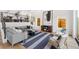 Cozy living room with a large sofa, accent chairs, and a decorative area rug at 3285 Lawrence St, Denver, CO 80205