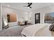 Bright main bedroom featuring modern ceiling fan and two sitting chairs at 3285 Lawrence St, Denver, CO 80205