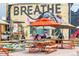 Outdoor patio area with picnic tables, umbrellas, and a food truck, perfect for community gatherings at 3285 Lawrence St, Denver, CO 80205
