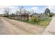 View of the backyard showing a long wooden fence and a gray single-Gathering home in the background at 4595 S Fox St, Englewood, CO 80110