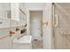 Bathroom featuring a single sink vanity and a shower and tub combination with tile surround at 4595 S Fox St, Englewood, CO 80110