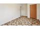 Bright bedroom with patterned carpet and folding closet doors at 4595 S Fox St, Englewood, CO 80110