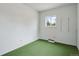 Bedroom featuring a bright window, neutral walls, and green carpet flooring at 4595 S Fox St, Englewood, CO 80110