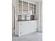 Close-up of a vintage built-in cabinet with glass doors and mirrored backsplash at 4595 S Fox St, Englewood, CO 80110
