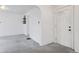 Bright entryway featuring an arched doorway, white walls, and gray carpet flooring at 4595 S Fox St, Englewood, CO 80110