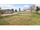 Large front yard showcasing greenery, a shed, and a house with red garage at 4595 S Fox St, Englewood, CO 80110