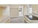 View of a kitchen with white appliances, a doorway, and floral wallpaper accents at 4595 S Fox St, Englewood, CO 80110