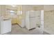 Functional kitchen with white appliances, yellow cabinets, and ample countertop space at 4595 S Fox St, Englewood, CO 80110