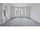 Spacious living room featuring bright windows, carpet flooring, and white walls at 4595 S Fox St, Englewood, CO 80110