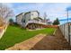 The spacious backyard features an oversized lawn and beautiful deck at 9275 Erminedale Dr, Lone Tree, CO 80124