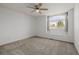 Bright bedroom featuring neutral carpet, white walls, a ceiling fan, and a window with bench seating at 9275 Erminedale Dr, Lone Tree, CO 80124