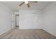 This bedroom features neutral carpet, white walls, and a ceiling fan at 9275 Erminedale Dr, Lone Tree, CO 80124