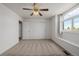 Bedroom featuring neutral carpet, white walls, a ceiling fan, and a window with bench seating at 9275 Erminedale Dr, Lone Tree, CO 80124