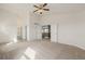 Bright bedroom featuring neutral carpet, white walls, and a ceiling fan with views of the hallway and staircase at 9275 Erminedale Dr, Lone Tree, CO 80124