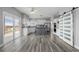 Kitchen and deck area with stainless steel appliances, white cabinets, gray island and sliding barn doors at 9275 Erminedale Dr, Lone Tree, CO 80124