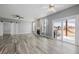 Comfortable living room featuring a fireplace, ceiling fans, sliding barn door, and a sliding glass door to the deck at 9275 Erminedale Dr, Lone Tree, CO 80124