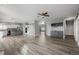 Expansive living space featuring wood floors, wet bar, a sliding barn door, and open views at 9275 Erminedale Dr, Lone Tree, CO 80124