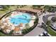 Overhead view of a community pool with lounge chairs, umbrellas, and landscaped areas for social gatherings at 17137 W 91St Ln, Arvada, CO 80007