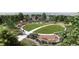 Aerial view of the community park with playgrounds, walking path, lush green lawn, and exercise equipment area at 17137 W 91St Ln, Arvada, CO 80007