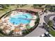 Aerial view of the outdoor community pool with lounge chairs and umbrellas, ideal for relaxation and recreation at 17137 W 91St Ln, Arvada, CO 80007