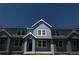 Charming two-story townhouse with gray siding, white trim, and bright windows under a deep blue sky at 17137 W 91St Ln, Arvada, CO 80007