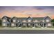 Charming townhome exterior showcasing a modern design with a landscaped front and neutral color palette at 17137 W 91St Ln, Arvada, CO 80007