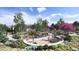 Vibrant community playground featuring a variety of play structures, including a slide and sand pit, surrounded by trees at 17137 W 91St Ln, Arvada, CO 80007