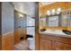 Bathroom featuring stylish vanity, wood trim, and unique wall texture at 11782 Gilpin St, Northglenn, CO 80233