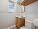 Bathroom featuring a wood vanity, a mirror and updated fixtures at 11782 Gilpin St, Northglenn, CO 80233