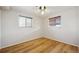 Bedroom featuring hardwood flooring and two windows offering natural light at 11782 Gilpin St, Northglenn, CO 80233